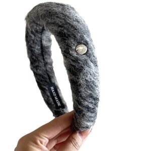 Grey plush thick knitted headband for women with handmade label and metal badge detail