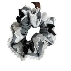 Blue-gray handmade scrunchie with delicate white lace trim and black ribbon bows