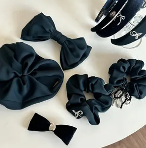 Detailed set of Prussian blue bow hair clips and scrunchies with elegant embroidery