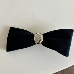Elegant black velvet bow hair clip with engraved silver metal piece for women
