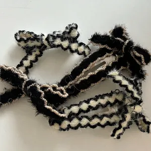 Knitted hair clips featuring black and white checkerboard bows and wool texture ribbons