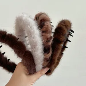 Detail of plush leopard print headband with anti-slip teeth in various natural colors
