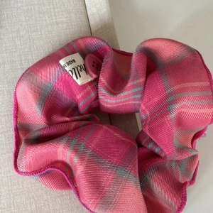 Pink and grey plaid scrunchie with button detail and a soft fabric texture