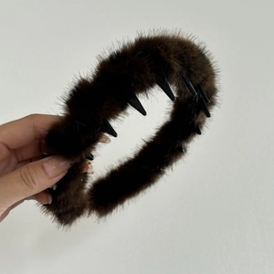 Detail of brown plush headband with inner non-slip teeth for secure hair styling