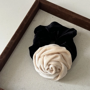 Detail of vintage velvet rose hair scrunchie with elegant contrast black and white texture