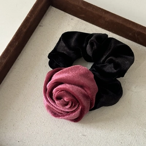 Detail of vintage velvet rose hair scrunchie with high elasticity and ribbed texture