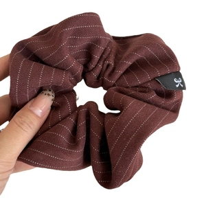 Deep red striped large fabric scrunchie for ponytails featuring an elegant bow logo label