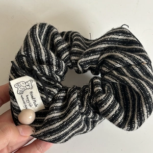 Handmade striped hair scrunchie with bear label, black bow, and pink bead accent