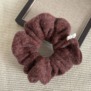 Vintage burgundy wool scrunchie with fluffy texture and decorative fabric tag