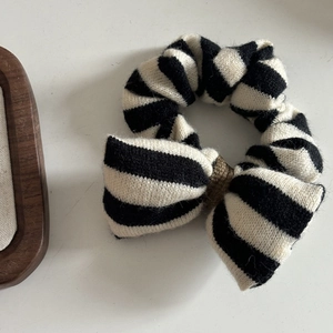 Classic black and white striped knit scrunchie with a stylish bow hair accessory