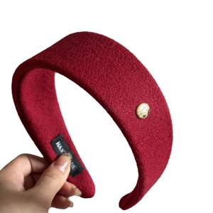 Deep red wool headband with high top design and vintage gold button detail