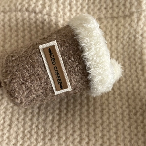 Close-up of iced coffee plush hair clip with brown teddy fleece and soft white faux fur detail