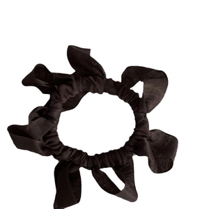 Elegant black pleated scrunchie with a glossy silk-like texture for ponytails