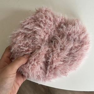 Detail view of oversized pink plush scrunchie with soft faux lamb wool texture