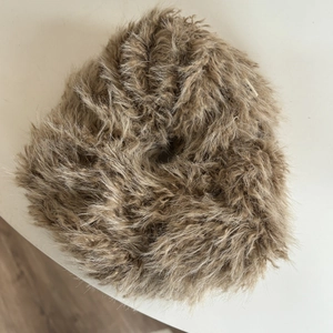 Close-up of soft brown faux fur oversized scrunchie showing fluffy texture and elastic core