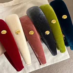 Set of six colorful velvet wide headbands with gold metallic circular engraved tags
