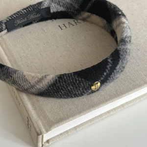 Plaid wool wide headband with golden emblem in classic black and grey color palette