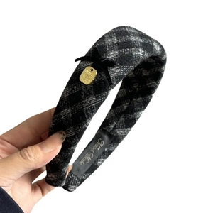Classic black and white plaid headband with velvet bow and gold pendant detail