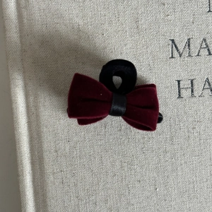 Close-up of vintage wine red velvet bow hair clip with elegant satin center detail