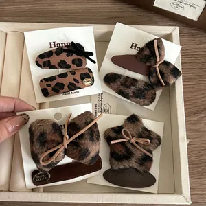 Vintage leopard print bow and star hair clip set for girls on a jewelry tray