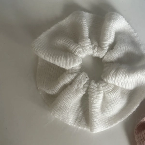 White knitted oversized scrunchie made of soft yarn for elegant autumn hairstyles