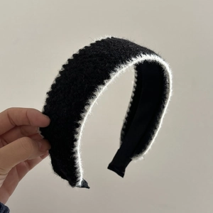 Elegant wide headband featuring black plush knit fabric and white faux fur contrast trim