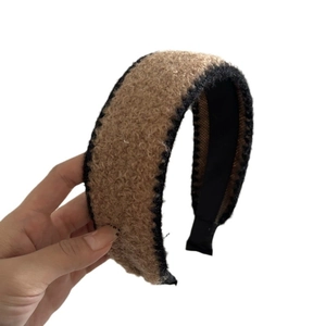 Plush wide headband in khaki faux fur with black contrast trim for winter styling