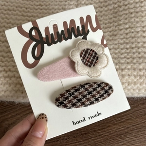 Pink bow and houndstooth flower hair clip set for girls on a display card