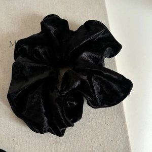 Elegant black velvet scrunchie with lace edges and premium soft texture for women