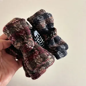 Elegant plaid tweed bow hair claw clip in reddish brown and black for bun hairstyle