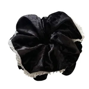 Elegant black velvet scrunchie with white lace trim for sophisticated hair styling