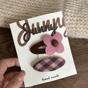 Detail of pink floral bow hair clip set on a Sunny handmade display card for girls