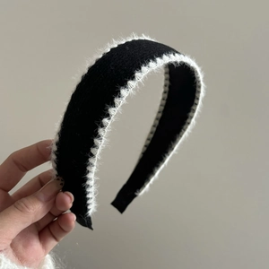 Elegant black knit headband with white faux fur trim for high crown hair styling effect