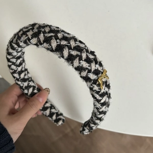 Classic black and white tweed padded headband featuring an elegant gold metal bow charm