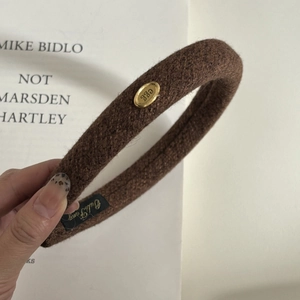 Premium wool oval gold tag headband in dark brown with a vintage minimalist aesthetic style