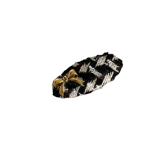 Vintage brown houndstooth hair clip with a gold metal bow detail on a white background