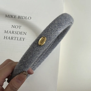 Blue tweed padded headband with oval gold metal buckle and vintage woven texture