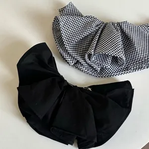Double-layered 3D bow hair clip in solid black and gingham fabric with spring fastener