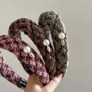 Detailed close-up of tweed wide headbands in pink, tan, and green with pearl and gold accents