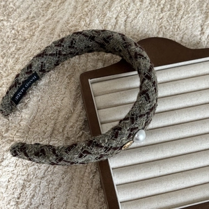 Vintage tweed plaid headband with gold metal button and pearl on wooden stand