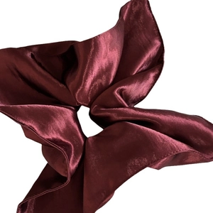 Deep burgundy satin scrunchie with a glossy finish and elegant pleated fabric design