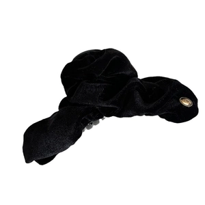 Large black velvet bow hair claw clip with golden LOVE lettering on white background