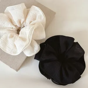 Detail of black and white 4-layer ruffled lace scrunchies with mesh texture fabric