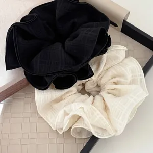 Elegant 4-layer ruffled hair scrunchies in black and white with textured relief fabric