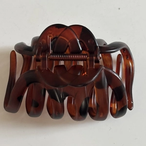 Detailed view of large tortoise shell hair claw clip with interlocking handle design