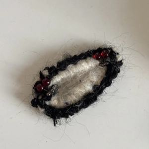 Handmade knitted hair clip with cherry beads and fuzzy black and white mohair textures
