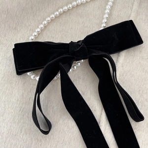 Elegant black velvet bow hair clip for women with vintage French style and soft texture