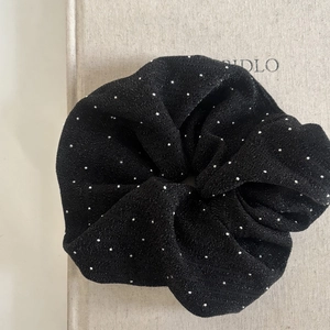 Elegant black fabric scrunchie with sparkling silver studs and textured ruffled design
