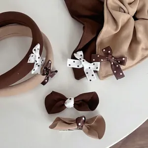 Caramel polka dot hair accessory set featuring bow headband, scrunchie and hair clip