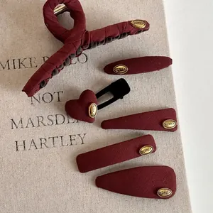 6-piece set of French red twill fabric hair clips with gold Korea labels on canvas